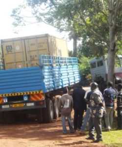 The huge lorry rumbles down the road to the Kisubi College. At a bend in the road it gets STUCK!